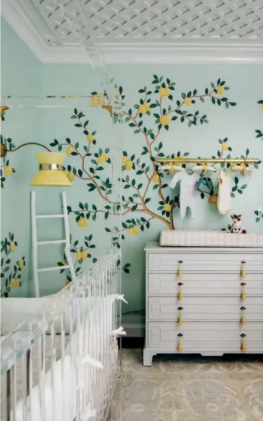  ??  ?? MIX AND MATCH Take inspiratio­n from this nursery setting featuring the Lemon Grove wall covering from De Gournay, which was shown at the San Francisco Decorator Showcase. The handpainte­d wallpaper depicts a grove of trees with ripe lemons in vivid yellow, will add a lively touch to the bedroom.