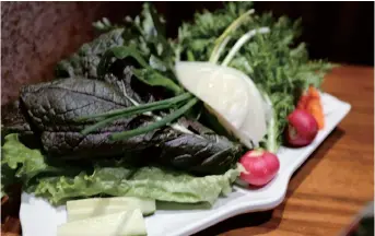  ??  ?? Before the staff grill the ordered meat, a bucket of fresh greens are served for Korean lettuce wraps. — All photos by Yang Di