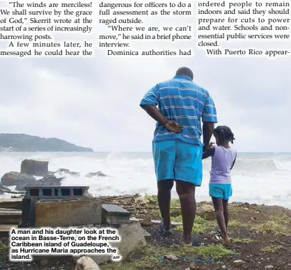  ?? AFP ?? A man and his daughter look at the ocean in Basse-Terre, on the French Caribbean island of Guadeloupe, as Hurricane Maria approaches the island.