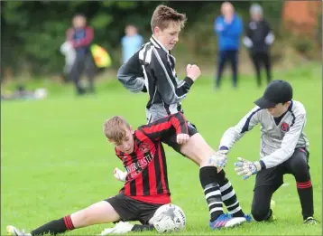  ??  ?? Ciaran Cotter and Sean Hoey of Bellurgan United and Eoin Maguire of Quay Celtic look to gain possession of the ball during the DSBL U-14 Premier League match at The Army Field.