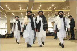  ?? HUSSEIN SAYED — THE ASSOCIATED PRESS ?? Afghanista­n’s Taliban delegation arrive for the agreement signing between Taliban and U.S. officials in Doha, Qatar, on Saturday.