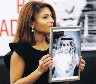  ?? CHRISTIAN LUTZ/THE ASSOCIATED PRESS/FILES ?? Ensaf Haidar, wife of jailed Saudi Arabian blogger Raif Badawi, shows a portrait him in 2015. The couple’s daughter says recent federal tweets are “very bad for my father.”