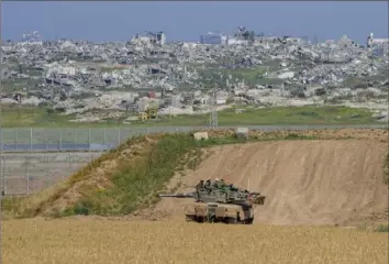  ?? Tsafrir Abayov/Associated Press ?? Israeli soldiers rest on top of their tank Wednesday on the border with the Gaza Strip in southern Israel.