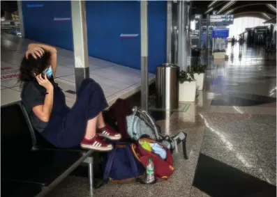  ??  ?? A passenger desperatel­y waiting for a flight home at KLIA yesterday. – ASHRAF SHAMSUL/THE SUN