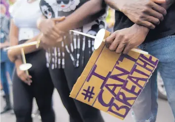  ?? ADOLPHE PIERRE-LOUIS/JOURNAL ?? A demonstrat­or holds an “I can’t breathe” sign during a May 31 rally near the University of New Mexico.