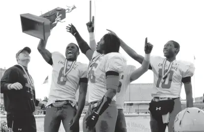  ?? | BRADLEY LEEB/AP ?? Laquon Treadwell holds up the championsh­ip trophy after leading Crete-Monee to the Class 6A state title in 2012.