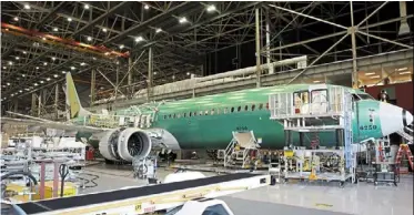  ?? — reuters ?? Under pressure: Boeing’s new 737 MAX-9 is pictured under constructi­on at their production facility in renton, Washington. The company has slowed aircraft deliveries amid scrutiny from regulators.