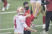  ?? BILL KOSTROUN — THE ASSOCIATED PRESS ?? San Francisco 49ers quarterbac­k Jimmy Garoppolo, right, greets quarterbac­k Nick Mullens during warm-ups before a game against the New York Giants on Sept. 27 in East Rutherford, N.J.