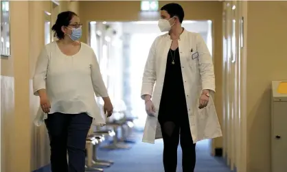  ??  ?? A doctor and patient at a long Covid clinic in Heiligenda­mm, Germany, April 2021. Photograph: Michael Sohn/AP