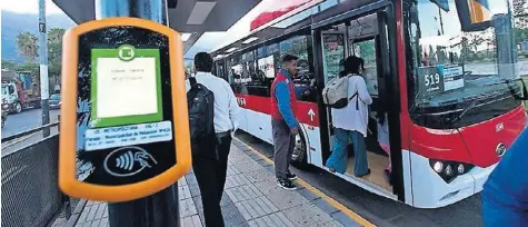  ??  ?? Pasajeros abordan un autobús eléctrico de la red de transporte público de Santiago de Chile.