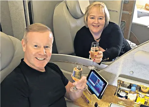  ??  ?? Lorraine Campbell had posted this photograph of herself and Neil Evans, her new husband, flying first class to the United Arab Emirates to start a new life in Dubai