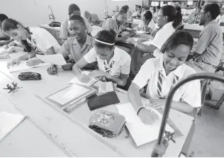  ?? FILE ?? In this 2011 photo, Campion College fifth form students are seen in a science class. In so many cases and in so many ways, students have their entire world views changed simply through their interactio­ns with their teachers.