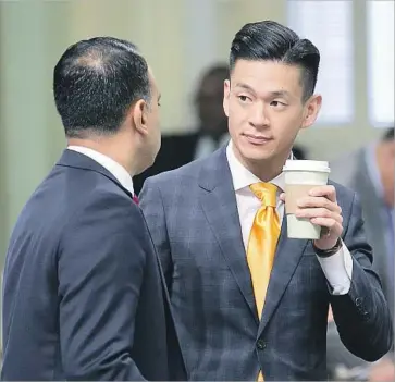  ?? Rich Pedroncell­i Associated Press ?? AMONG the approved bills was a proposal by Assemblyma­n Evan Low, right, that will allow people to make a donation when filing their personal income taxes to help law enforcemen­t agencies test their rape kits.