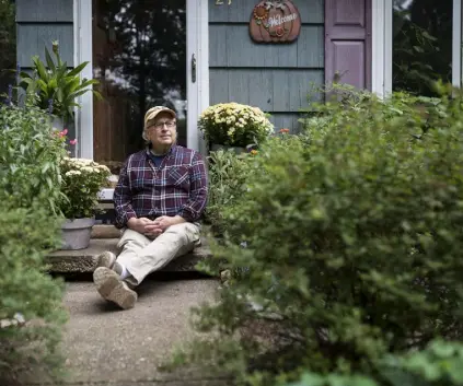 ?? Photos by Karsten Moran, © The New York Times Co. ?? Bill Jacobs, founder of the St. Kateri Conservati­on Center, sits outside his home in October in Wading River, N.Y. Bill and Lynn Jacobs’ fight for biodiversi­ty started right outside their house.