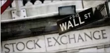  ?? MARK LENNIHAN — THE ASSOCIATED PRESS FILE ?? This photo shows a Wall Street street sign outside the New York Stock Exchange.