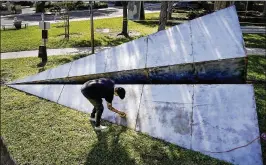  ?? RICHARD GRAULICH / THE PALM BEACH POST 2016 ?? Artist Griffin Loop of Los Angeles installs “Launch Intention,” a 25-foot steel sculpture in the shape of a paper airplane off Flagler Drive in West Palm Beach last year for the Canvas outdoor museum show.