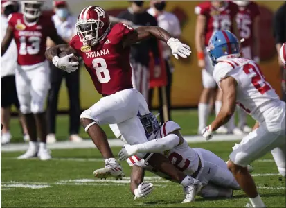  ?? CHRIS O’MEARA — THE ASSOCIATED PRESS ?? Indiana running back Stevie Scott III (8) slips a tackle by Mississipp­i linebacker Jacquez Jones during the first half of the Outback Bowl on Saturday in Tampa, Fla.