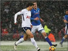  ??  ?? Heung-Min Son scores the fifth Spurs goal in the 63rd minute as Rochdale’s Ryan Delaney looks on during the FA Cup fifth round replay in Wembley on Wednesday.