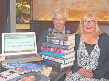  ?? ?? Caption Book smart in here Angela Seaton demonstrat­es to Rotarian Gordon Robb from the Bridge of Allan and Dunblane Rotary Club the range of the library’s printed materials, together with its multi-media outreach capability