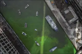  ?? ERIN HOOLEY — THE ASSOCIATED PRESS ?? The Chicago River in Chicago is dyed green on Saturday.