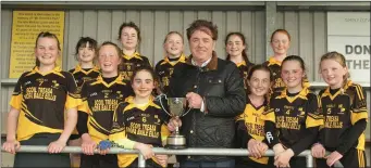  ??  ?? The Ballyellis girls receiving the trophy from Jim Dempsey of the Rackard League.