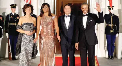  ?? — AP ?? WASHINGTON: President Barack Obama and first lady Michelle Obama pose for a photo as they greet Italian Prime Minister Matteo Renzi and his wife Agnese Landini on the North Portico for a State Dinner at the White House.