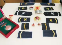  ??  ?? Xu Jiaping’s epaulets, collar buttons and cap badges along with the medals during his military service, are presented. — Yang Yang