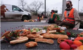  ?? Photograph: Christian Mang/Reuters ?? Activists in Berlin, Germany, block a highway to protest against food waste and for agricultur­al change to reduce greenhouse gas emissions.