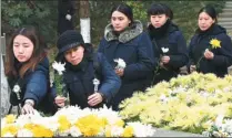  ?? PHOTOS BY SUN CAN/ XINHUA, WANG YE / XINHUA ?? Above: Members of the public place flowers on Wednesday for victims in Beijige, Nanjing, one of the sites where the Nanjing Massacre took place 80 years ago. Below: The State ceremony for the National Memorial Day for Victims of the Nanjing Massacre...