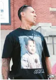  ?? SPENCER PLATT/GETTY ?? A cousin of Buffalo shooting victim Roberta Drury wears a shirt with her image as a baby.