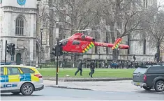  ??  ?? An air ambulance landed in Parliament Square to treat the attacker and police officer