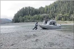  ?? GILLIAN FLACCUS — THE ASSOCIATED PRESS FILE ?? Hunter Maltz, a fish technician for the Yurok tribe, pushes a jet boat into the low water of the Klamath River last year in Humboldt County.