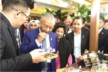  ??  ?? Prime Minister Dr Mahathir (second left) and wife Tun Dr Siti Hasmah Mohd Ali are seen visiting the Malaysia Durian Festival exhibition booth in Beijing, China.