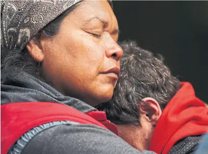  ?? CHAD HIPOLITO THE CANADIAN PRESS ?? Tent City founder Chrissy Brett consoles Lynn Hibak after learning they must vacate a park near Victoria. They later won a reprieve.