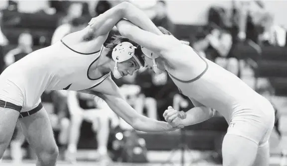  ?? BRIAN KRISTA/BALTIMORE SUN MEDIA GROUP ?? Winters Mill's Trevor Fawley, left, works his way to a victory over Liberty's McClain Butler in the 170-pound final during the Carroll County championsh­ip wrestling tournament.