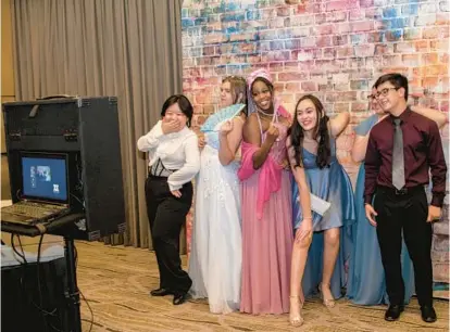  ?? ALBERT EWING/FOR BALTIMORE SUN ?? Attendees for Centennial’s prom pose at a photo booth at The Hotel at Arundel Preserve on April 23.