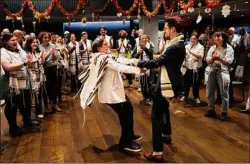  ?? James Estrin / The New York Times ?? Rabbi Sharon Kleinbaum and Cantor Sam Rosen dance during a celebratio­n at Congregati­on Beit Simchat Torah in Manhattan. New York City is home to some of the most spirituall­y and culturally diverse areas in the world.