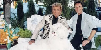  ?? Peter Bischoff / Getty Images ?? Siegfried & Roy were partners on and off Las Vegas stages. They performed as illusionis­ts with their famous white tigers. Siegfried Fischbache­r is dead at age 81 after a cancer battle.