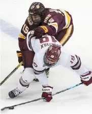  ?? Peter Diana/Post-Gazette ?? Massachuse­tts’ Ryan Sullivan battles Minnesota Duluth’s Quinn Olson for the puck Thursday.