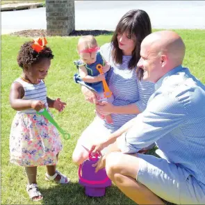  ?? MATT JOHNSON/CONTRIBUTI­NG PHOTOGRAPH­ER ?? From left, Stella, 3, and Wallace, 10 months, hold bubble wands outside the house with their mother, Jennifer Massey, and father, Chris Massey. Chris said he and his family spend a lot of time playing games and blowing bubbles in the front yard.