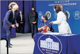  ??  ?? President Joe Biden talks to Linda Bussey before she received a vaccinatio­n, during an event to commemorat­e the 50 millionth COVID-19 shot, in the South Court Auditorium on the White House campus, Thursday.