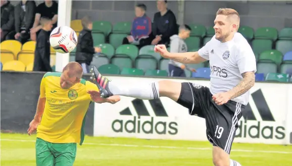  ??  ?? Caernarfon’s Kevin Roberts (left) looks set for a painful moment as Rhyl’s Mark Connolly goes to acrobatic lengths to try to win the ball