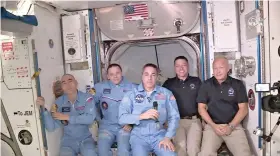  ?? NASA via AP ?? This photo provided by NASA shows Bob Behnken and Doug Hurley, far right, joining the the crew at the Internatio­nal Space Station on Sunday