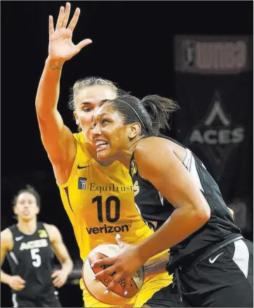  ?? Richard Brian ?? Las Vegas Review-journal @vegasphoto­graph Aces rookie A’ja Wilson takes Los Angeles defender Maria Vadeeva (10) to the basket in Friday’s victory.