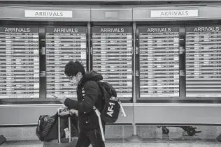  ?? Jahi Chikwendiu / Washington Post ?? Airlines continue to adjust schedules, canceling more than 1,100 flights Tuesday and delaying an additional 1,100, stranding travelers seeking to get back home from the holiday weekend.