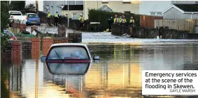  ?? GAYLE MARSH ?? Emergency services at the scene of the flooding in Skewen.