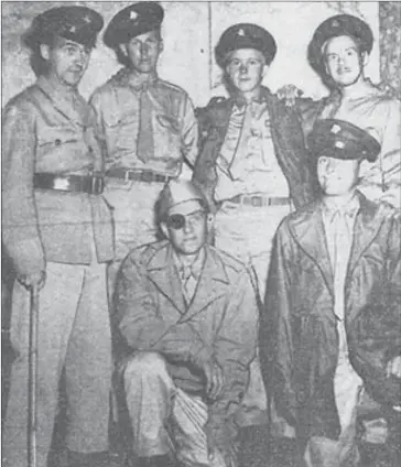  ??  ?? Canadian soldiers, after their liberation, wearing uniforms loaned to them by the Americans. Llewellyn (Bill) Doull stands in the back row, second from the left. (Source: Murray Doull)