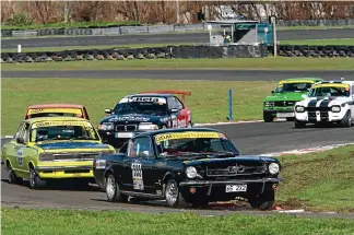  ??  ?? Above, Grant Rivers in the Mustang 289 Fastback leads the Classic Cup field. At right Kerry Halligan in the Crawford Pontiac and Adam Newell in the Crawford Ford brake heavily going into Splash during GT Cup racing.
Photos: STEW WOOD PHOTOGRAPH­Y.