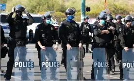  ?? Photograph: Ash Ponders/Reuters ?? Police block protesters as Donald Trump visits Phoenix last month.