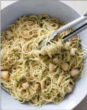  ?? DANIEL J. VAN ACKERE — AMERICA’S TEST KITCHEN VIA ASSOCIATED PRESS ?? This undated photo provided by America’s Test Kitchen in May 2018 shows spaghetti with lemon, basil and scallops in Brookline, Mass. This recipe appears in the cookbook “Cooking At Home With Bridget And Julia.”